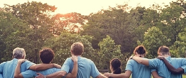 HR on Purpose People put their arms around each other as a symbol of teamwork.