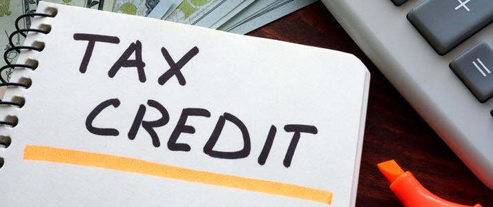 photo of tax credit written on notebook photo of tax credit written on notebook