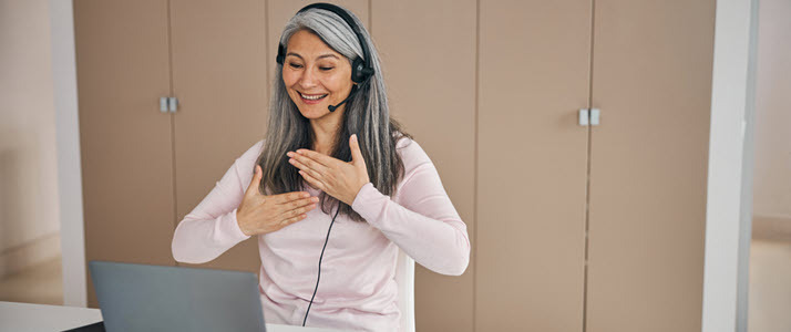 Woman wearing headset using ASL to communicate video meeting