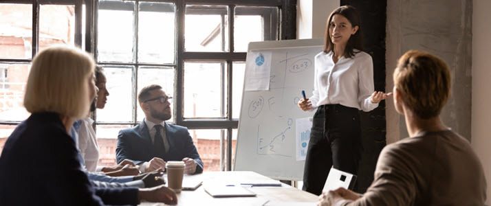 female leader speaking to group in conference room female leader speaking to group in conference room
