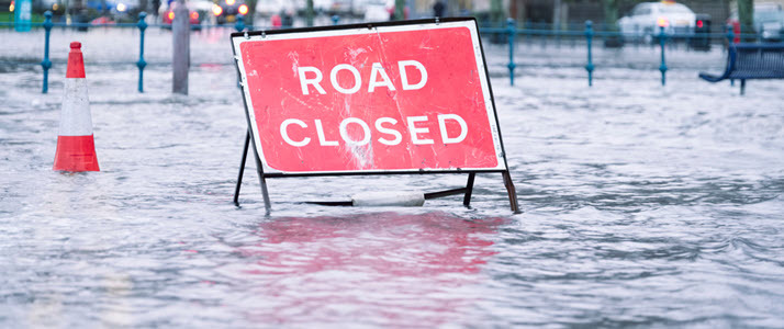 photo of a road closed sign on flooded road photo of a road closed sign on flooded road