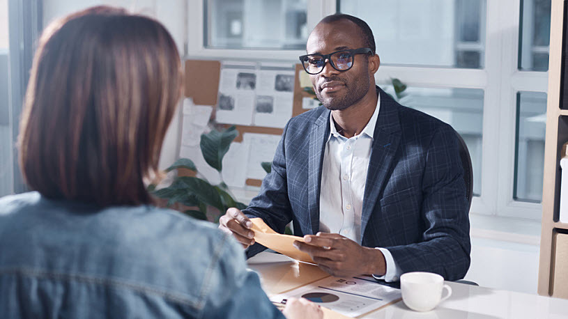 Young Black businessman meeting with management in office Young Black businessman meeting with management in office