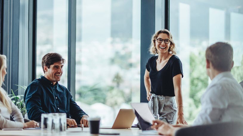 Skills-Based Hiring Four coworkers gather around a conference table.