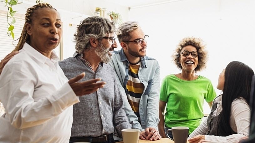 five diverse coworkers laughing and talking during coffee break five diverse coworkers laughing and talking during coffee break