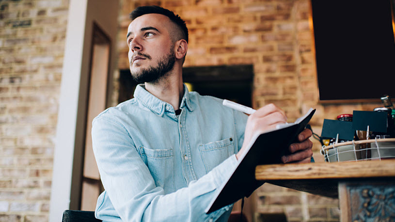 Contemplative young male entrepreneur making notes Contemplative young male entrepreneur making notes