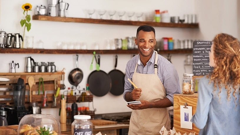 Barista takes an order from a customer at coffee shop Beyond the Clock: Answering FAQs About Overtime Laws