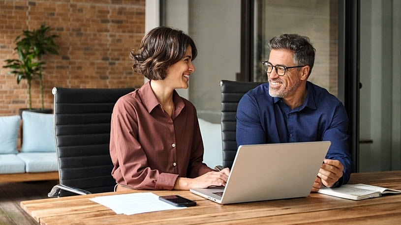 Two smiling retirement plan benefit administrators meeting New Catch-up Contribution Rules: What Retirement Plan Sponsors Need to Know