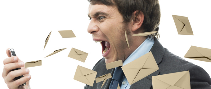 Email in the Workplace: How to Reduce Information Overload An employee yells at his work phone for getting so many emails.